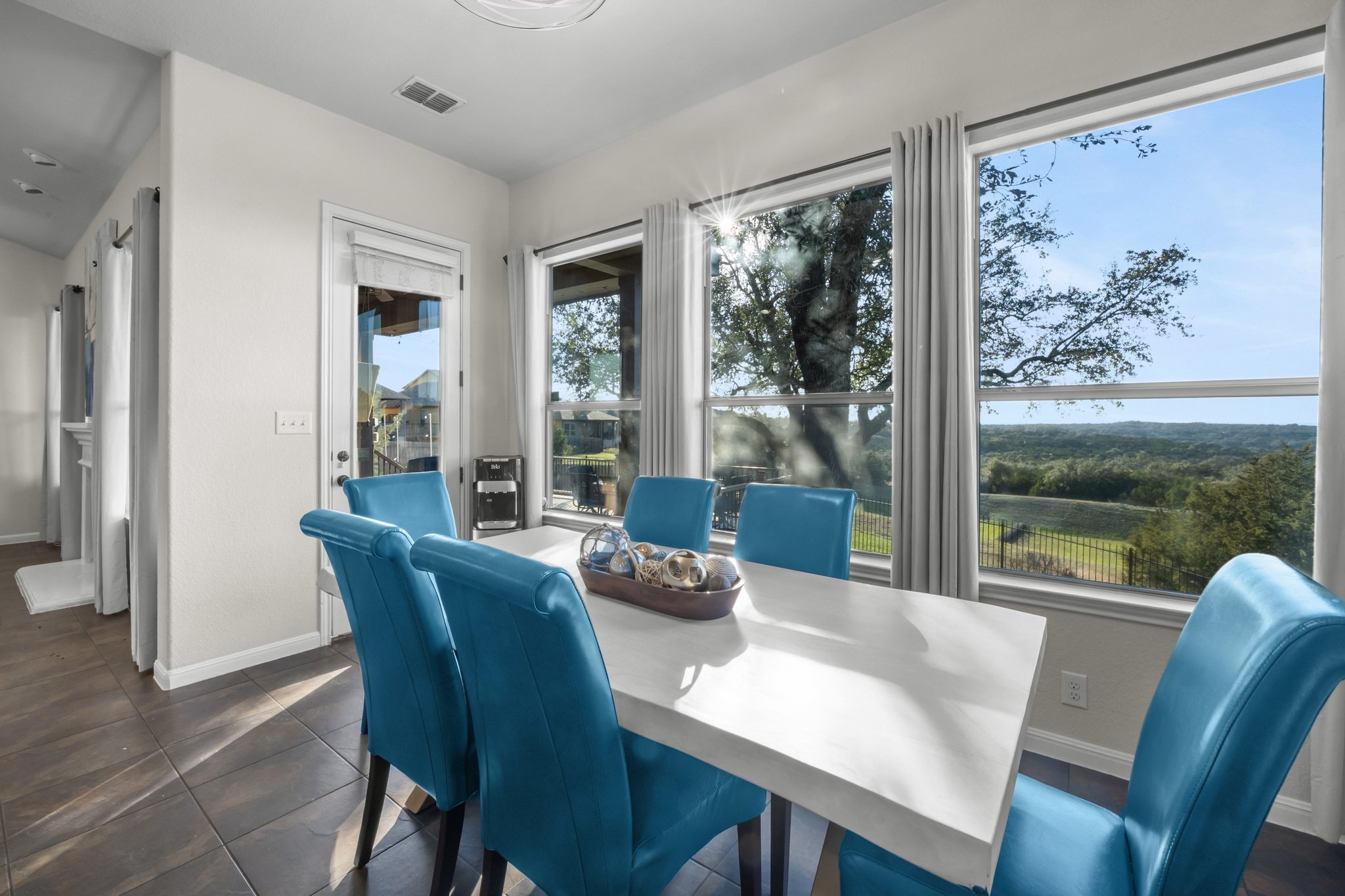 22112 Rock Wren Road Spicewood, TX 78669 - Photo 15 of 40 Dining area featuring baseboards and dark tile patterned floors