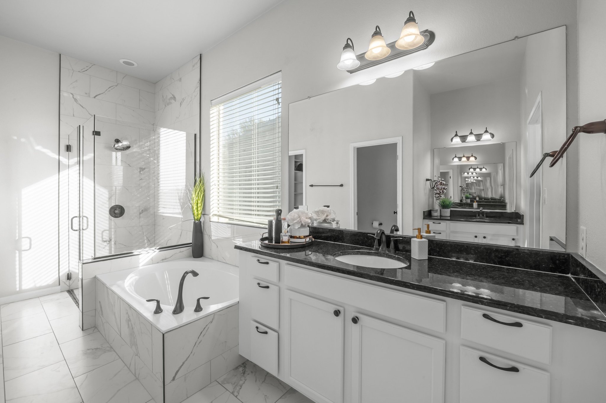 22112 Rock Wren Road Spicewood, TX 78669 - Photo 18 of 40 Bathroom with a marble finish shower, vanity, a bath, and light marble finish flooring