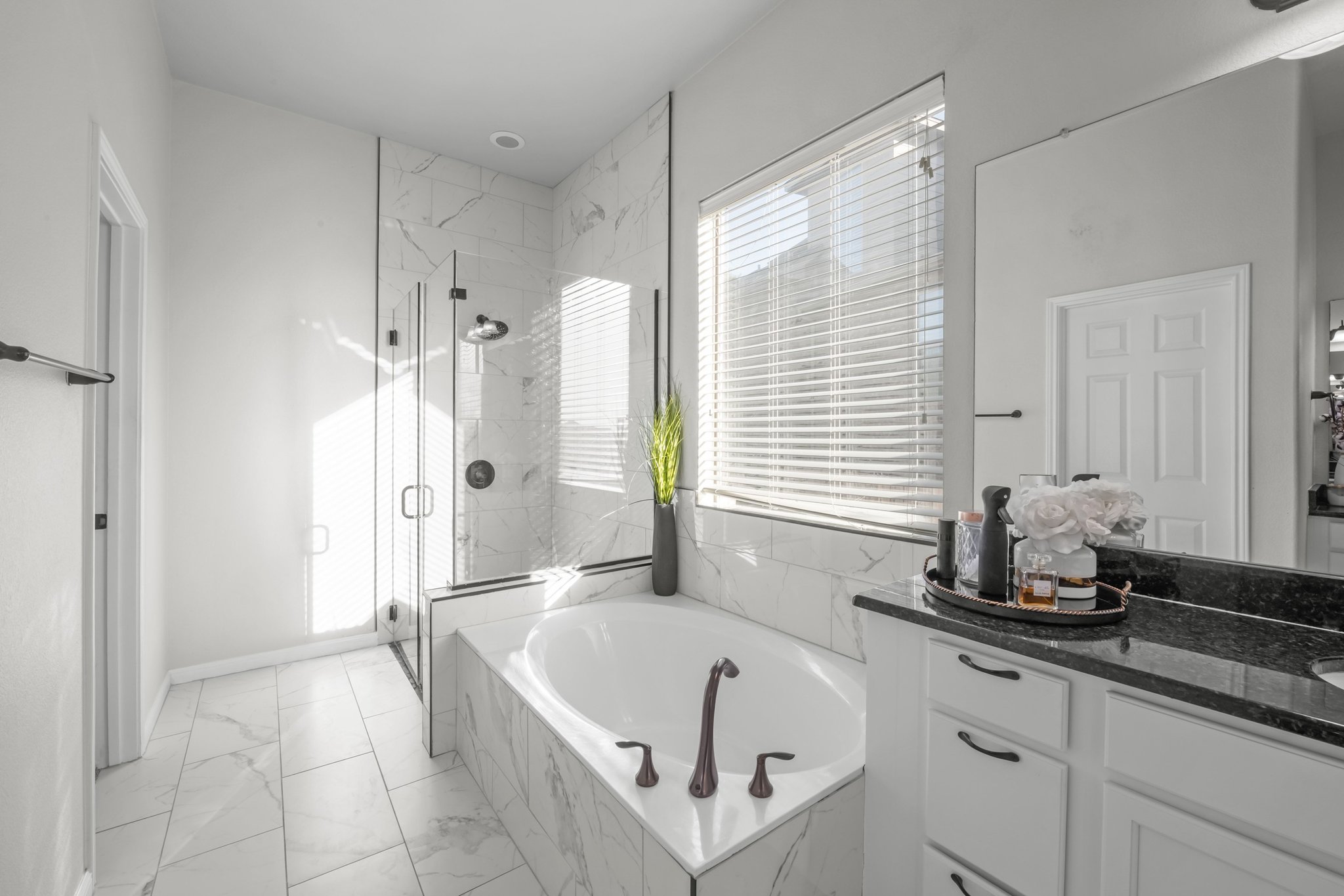 22112 Rock Wren Road Spicewood, TX 78669 - Photo 19 of 40 Full bathroom with a marble finish shower, vanity, a garden tub, and light marble finish floors