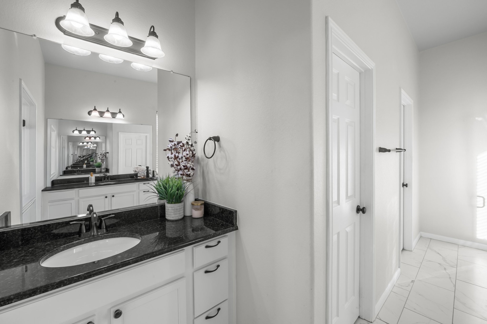 22112 Rock Wren Road Spicewood, TX 78669 - Photo 20 of 40 Bathroom featuring light marble finish floors and vanity