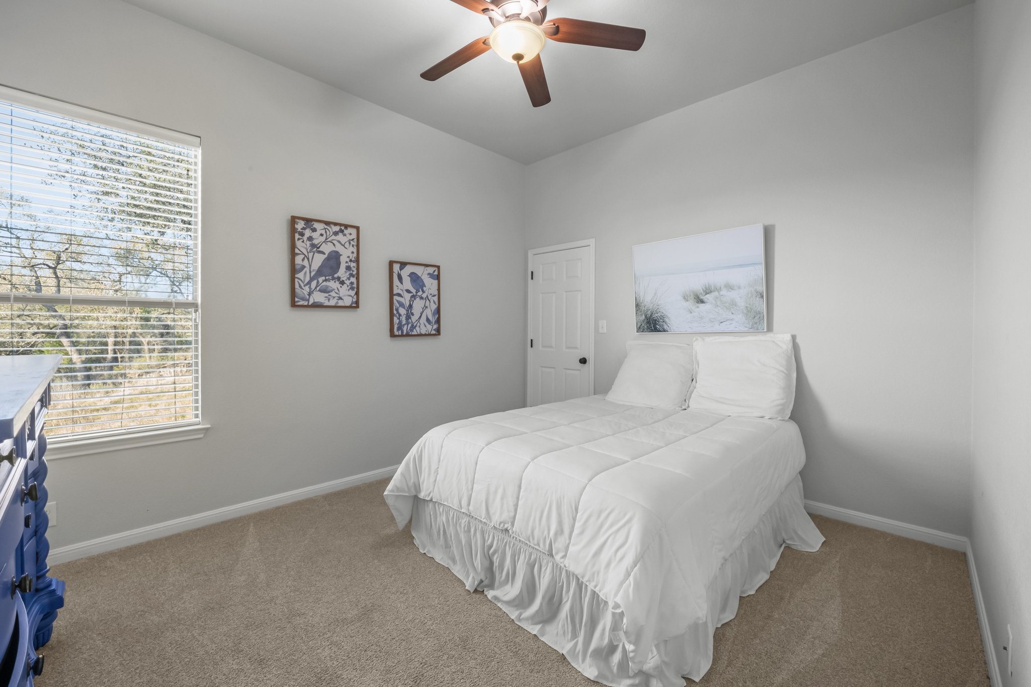 22112 Rock Wren Road Spicewood, TX 78669 - Photo 23 of 40 Carpeted bedroom with a ceiling fan and baseboards