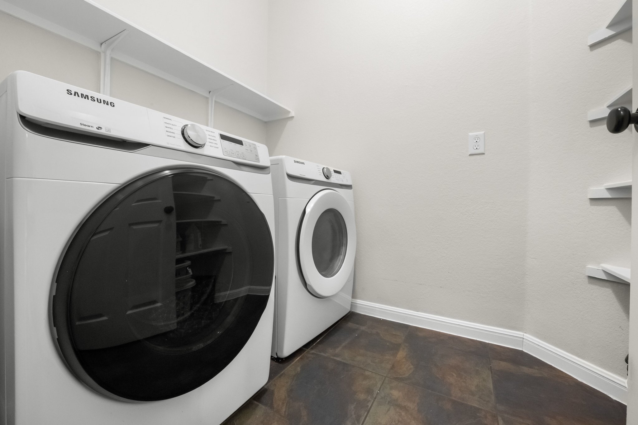 22112 Rock Wren Road Spicewood, TX 78669 - Photo 25 of 40 Laundry room featuring washer and dryer and baseboards