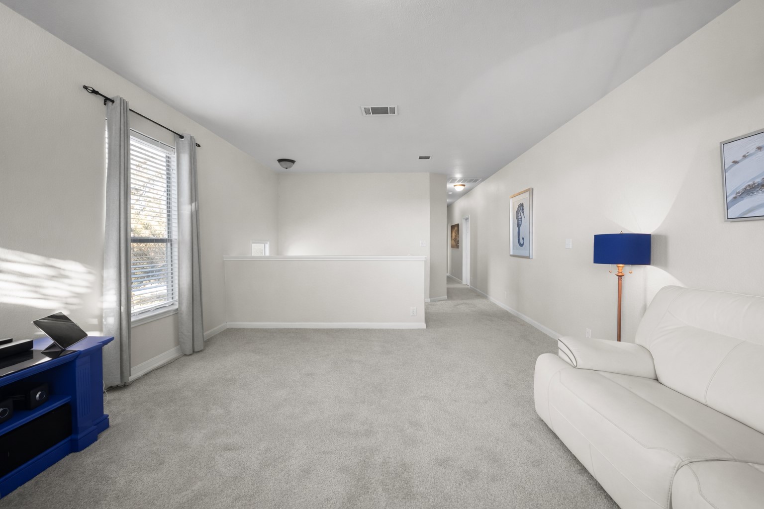 22112 Rock Wren Road Spicewood, TX 78669 - Photo 29 of 40 Living area with carpet floors and baseboards