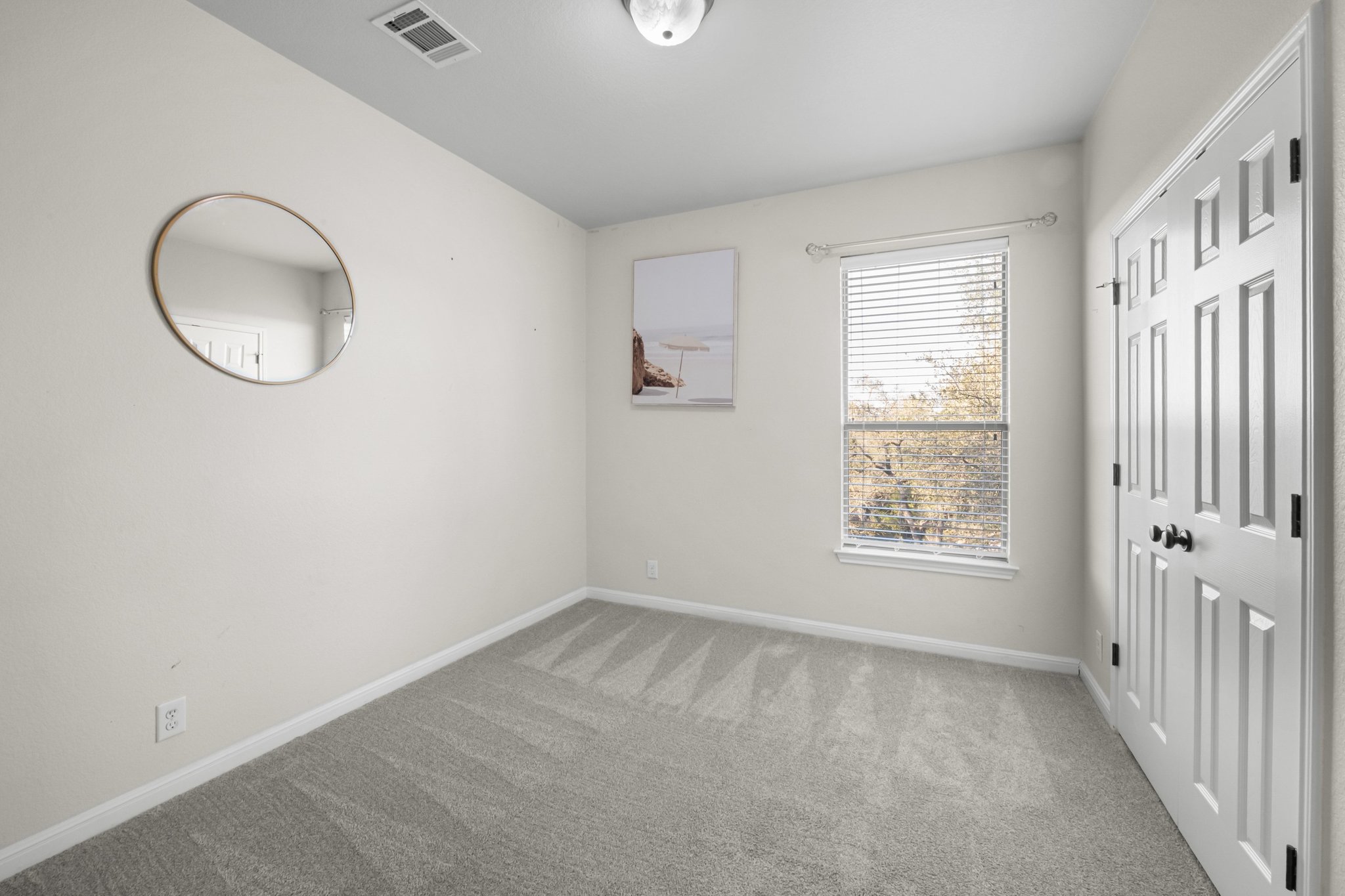 22112 Rock Wren Road Spicewood, TX 78669 - Photo 31 of 40 Unfurnished bedroom featuring light carpet and baseboards