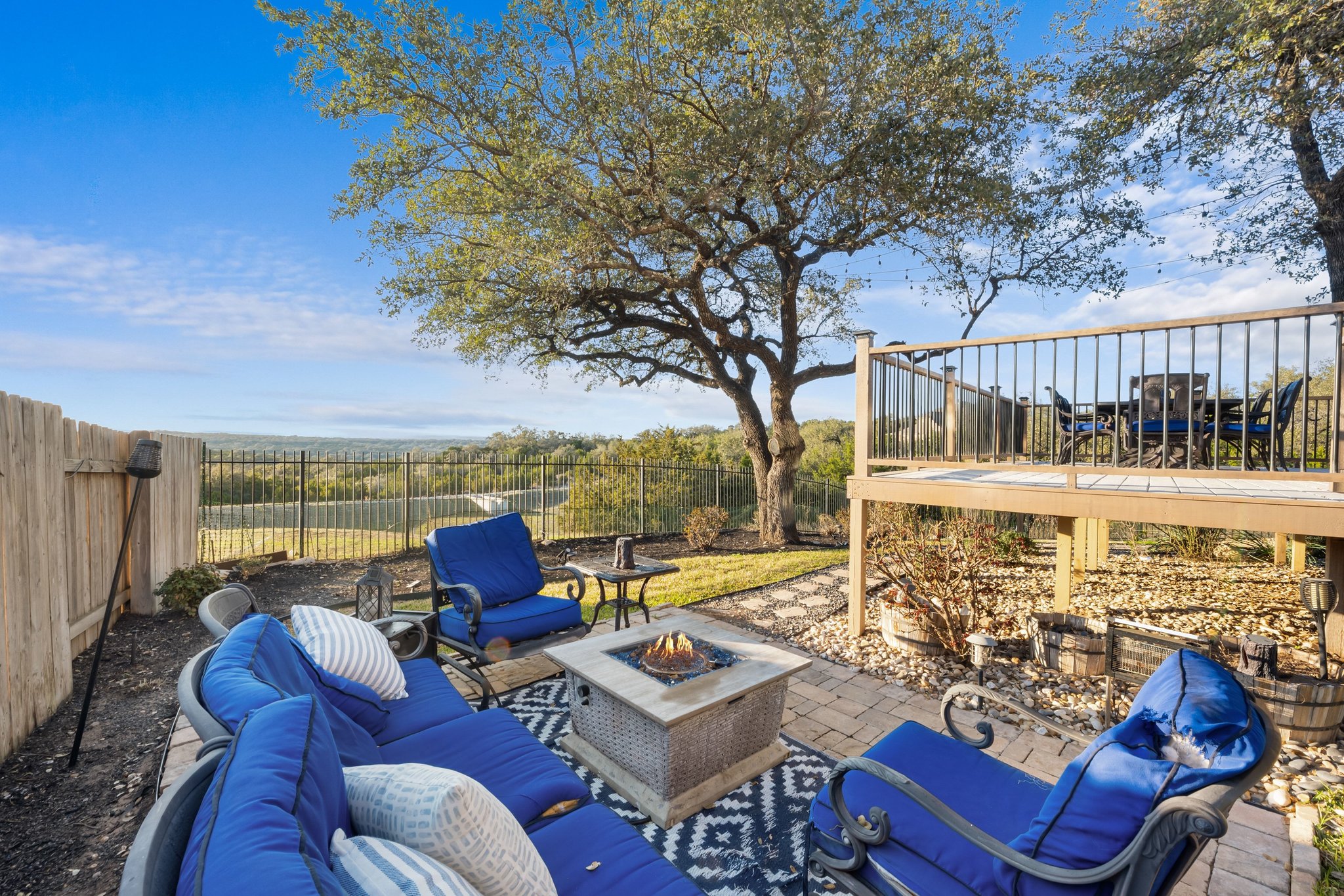 22112 Rock Wren Road Spicewood, TX 78669 - Photo 38 of 40 Fenced backyard with a patio and an outdoor living space with a fire pit