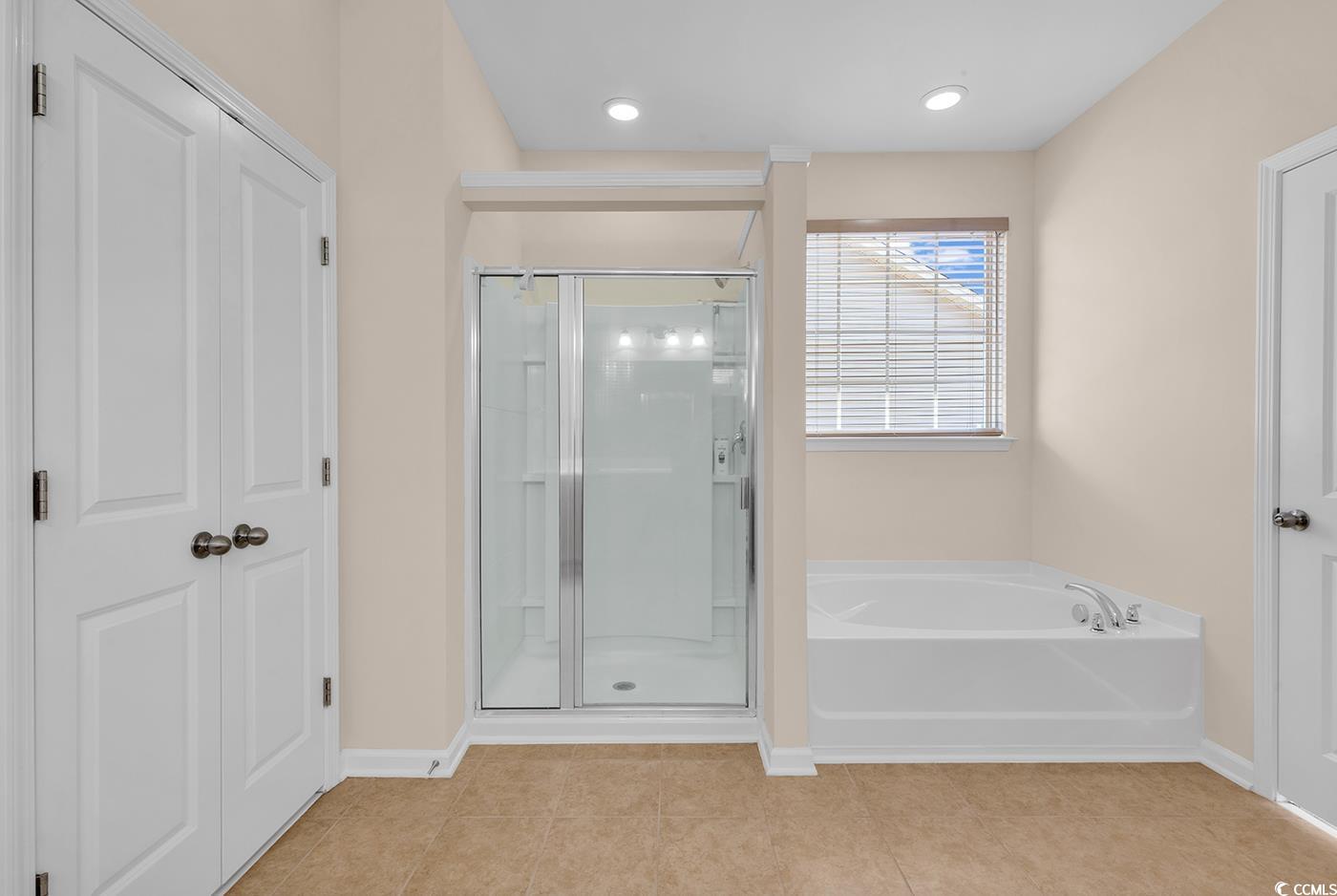 1612 Fairforest Court Conway, SC 29526 - Photo 25 of 40 Bathroom featuring a garden tub, a stall shower, and light tile patterned floors