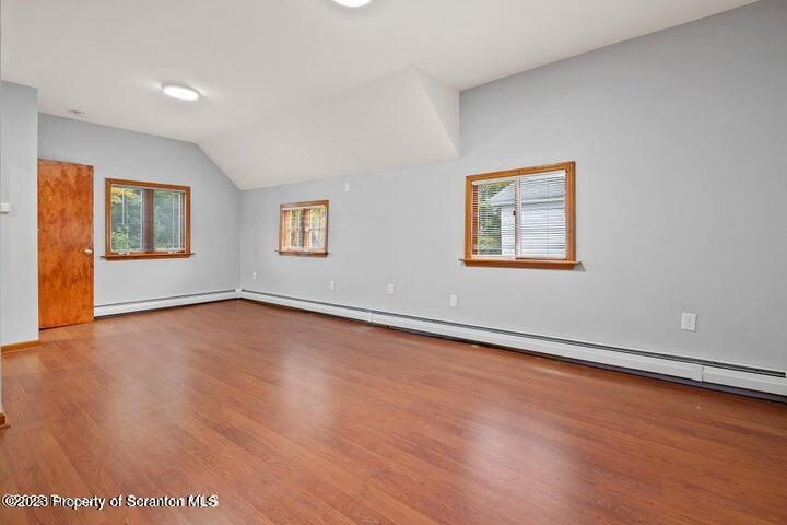 1703 Sanderson Street Scranton, PA 18512 - Photo 12 of 24 a view of an empty room with wooden floor and a window