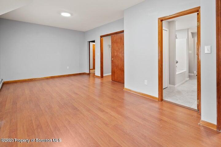1703 Sanderson Street Scranton, PA 18512 - Photo 13 of 24 a view of an empty room with wooden floor and a window