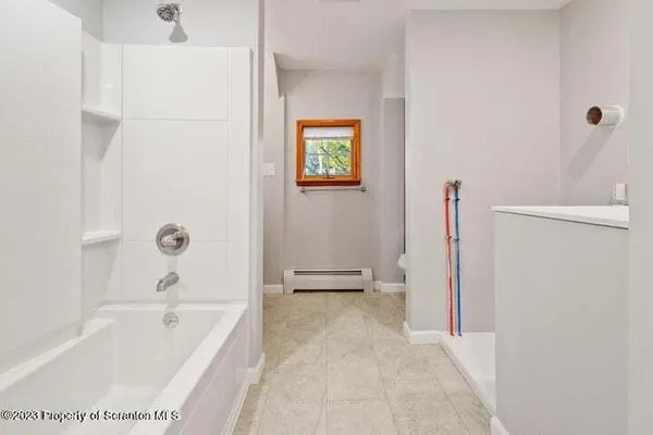 a bathroom with a bathtub and a shower