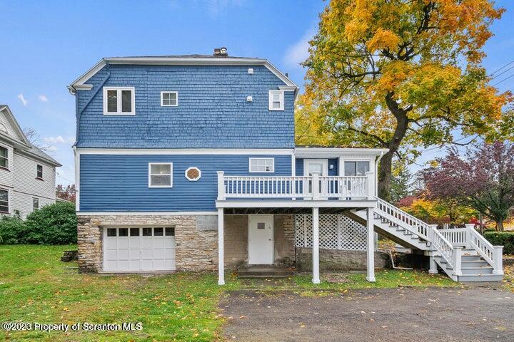 1703 Sanderson Street Scranton, PA 18512 - Photo 15 of 24 a view of a brick house with large windows and a yard