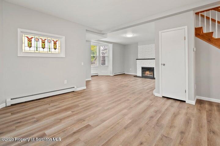 1703 Sanderson Street Scranton, PA 18512 - Photo 6 of 24 a view of an empty room with wooden floor and a window