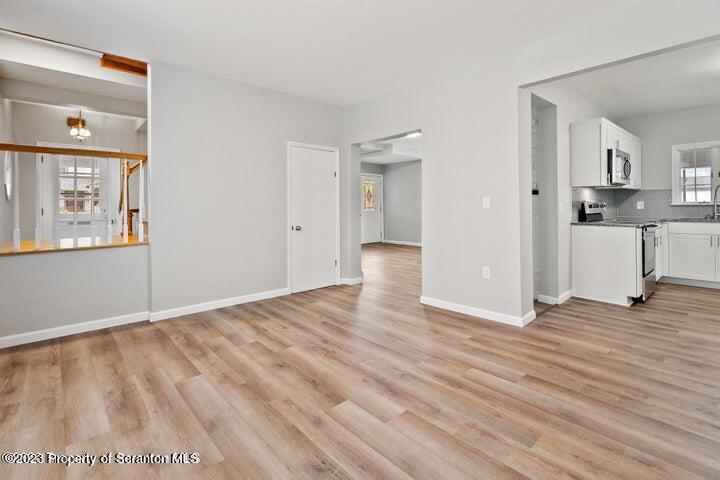 1703 Sanderson Street Scranton, PA 18512 - Photo 8 of 24 a view of a room with wooden floor and a window