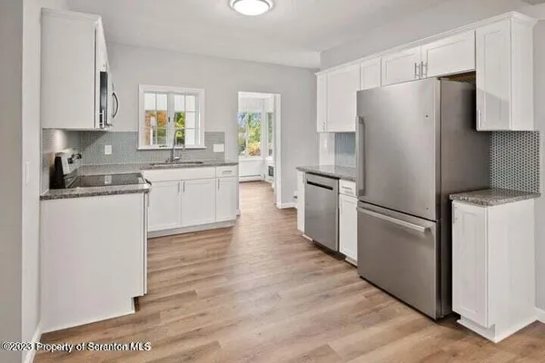 a kitchen with a refrigerator stove and sink