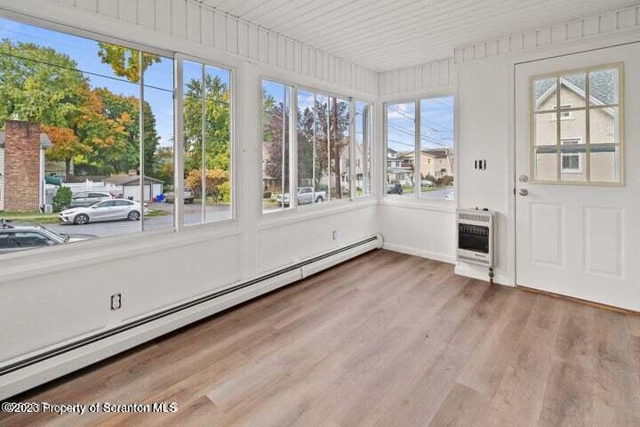 1703 Sanderson Street Scranton, PA 18512 - Photo 10 of 24 a view of an empty room with a window and wooden floor