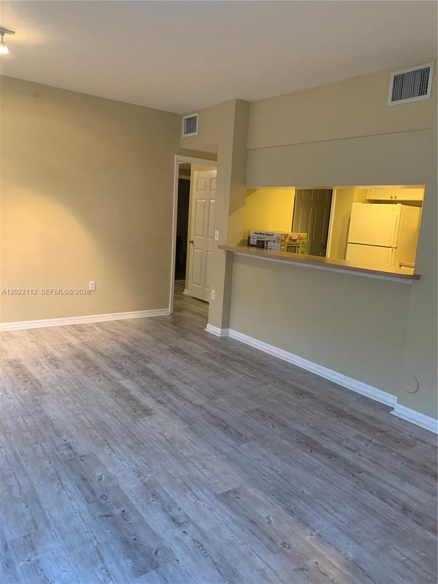 6572 West Sample Road, Unit 6572 Coral Springs, FL 33067 - Photo 15 of 17 a view of empty room with wooden floor
