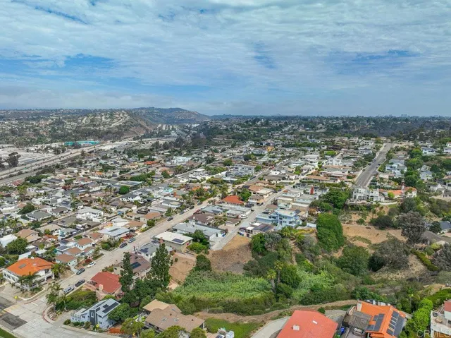 an aerial view of residential building and trees around
