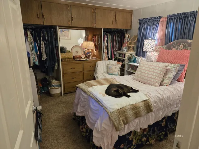 a bed sitting in a room next to a window