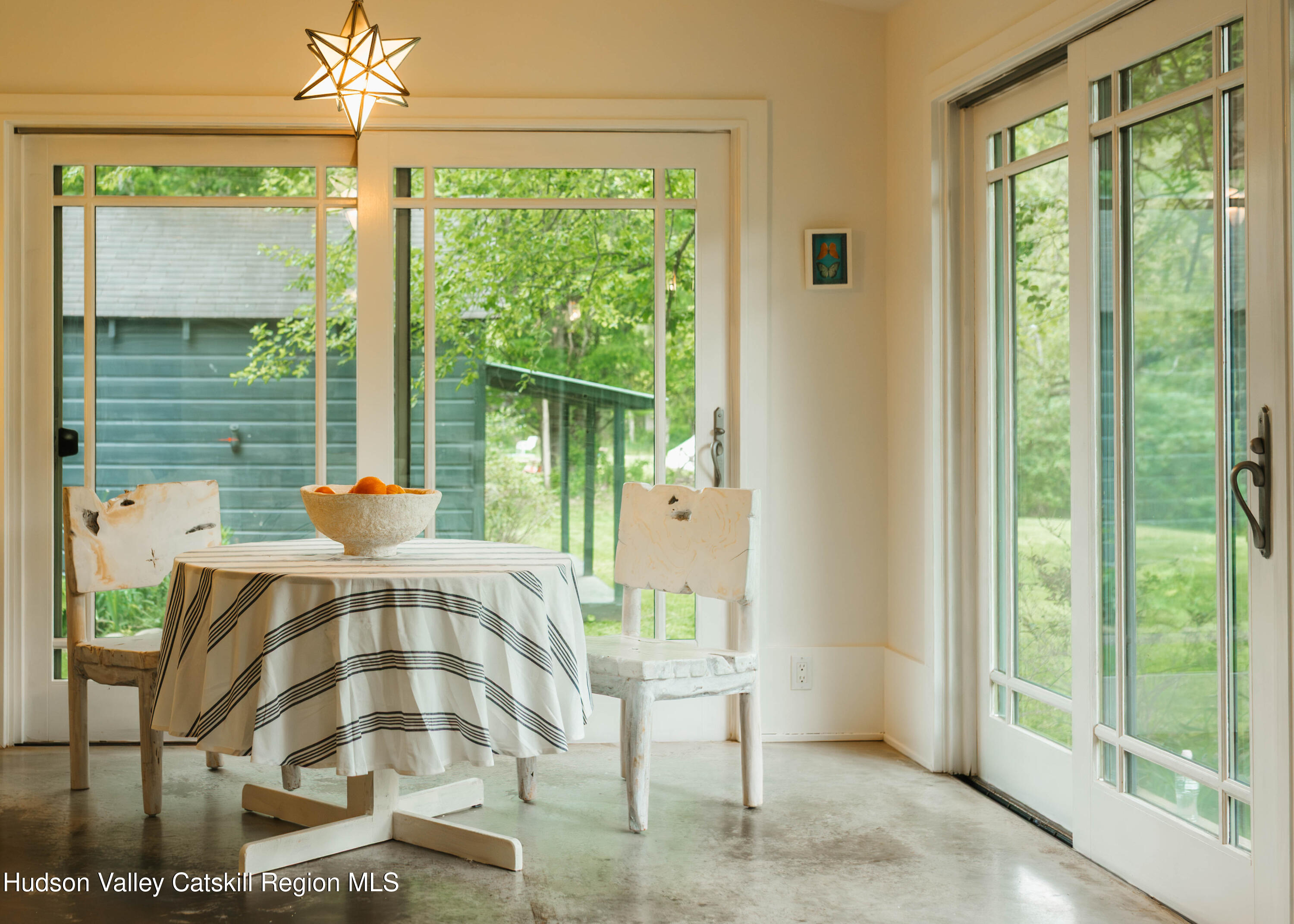 675 Cooper Lake Road Woodstock, NY 12448 - Photo 23 of 31 a view of a dining room with furniture window and outside view