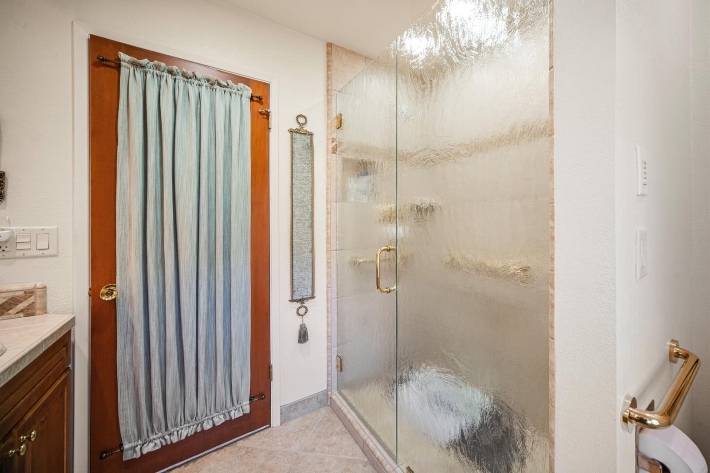 2911 Colton Road Pebble Beach, CA 93953 - Photo 33 of 46 a bathroom with a glass shower door