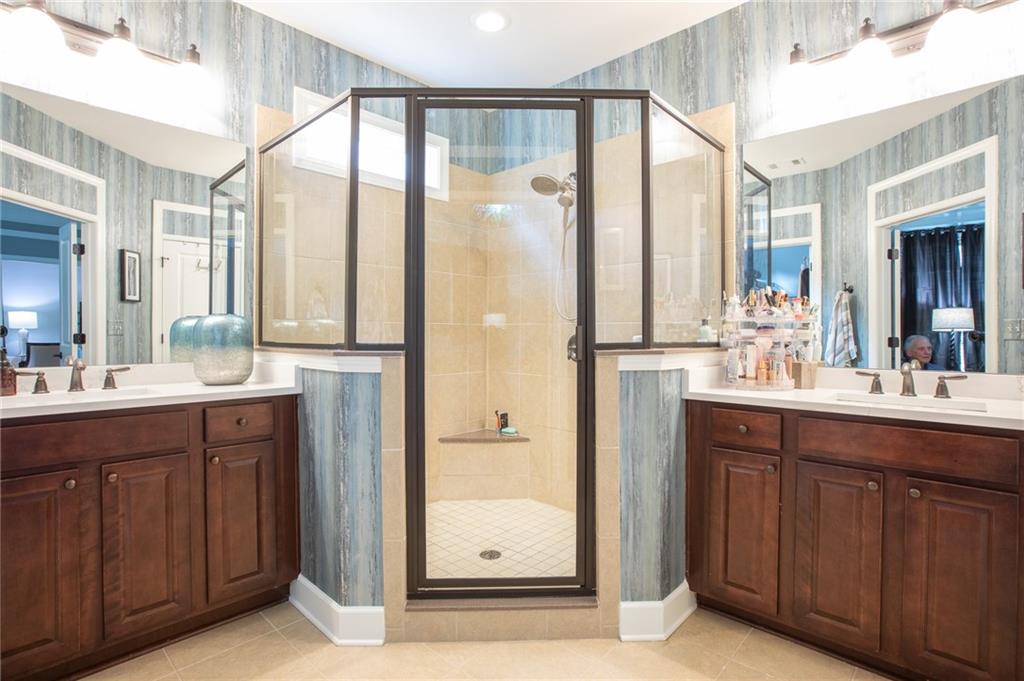 3538 Black Cherry Point Gainesville, GA 30504 - Photo 14 of 44 a bathroom with a double vanity sink and mirror with shower