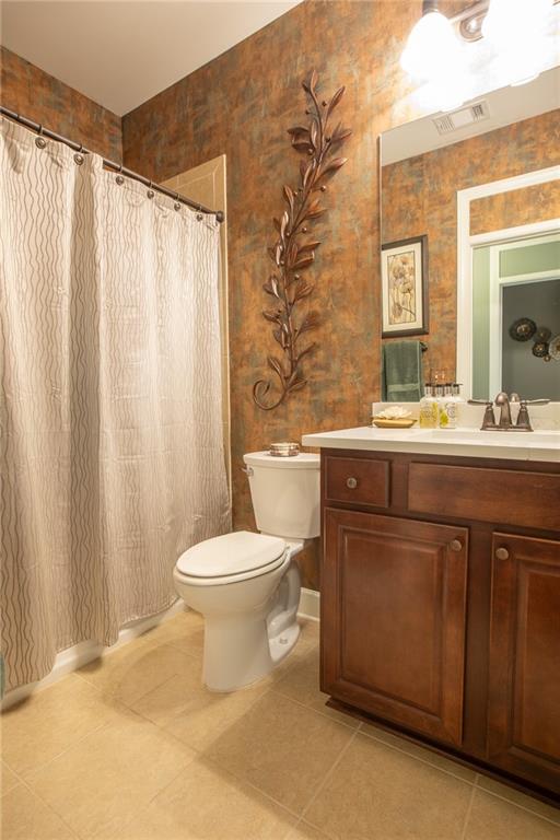 3538 Black Cherry Point Gainesville, GA 30504 - Photo 18 of 44 a bathroom with a double vanity sink toilet and a mirror