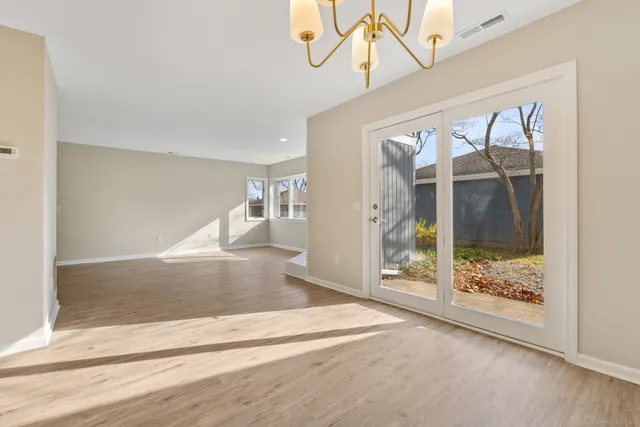 a view of a room window and wooden floor