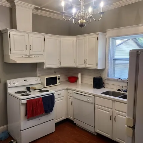a kitchen with a sink a refrigerator and window