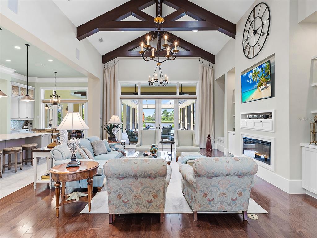 16336 Daysailor Trail Lakewood Ranch, FL 34202 - Photo 21 of 88 a living room with furniture a chandelier and a large window