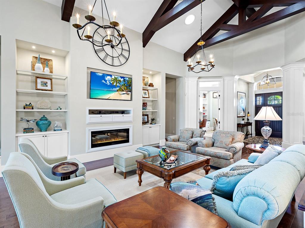 16336 Daysailor Trail Lakewood Ranch, FL 34202 - Photo 22 of 88 a living room with furniture a fireplace and wall paintings