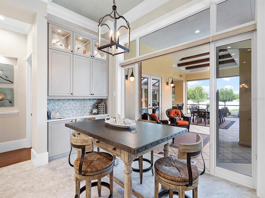 16336 Daysailor Trail Lakewood Ranch, FL 34202 - Photo 32 of 88 a view of a dining room with furniture wooden floor and chandelier
