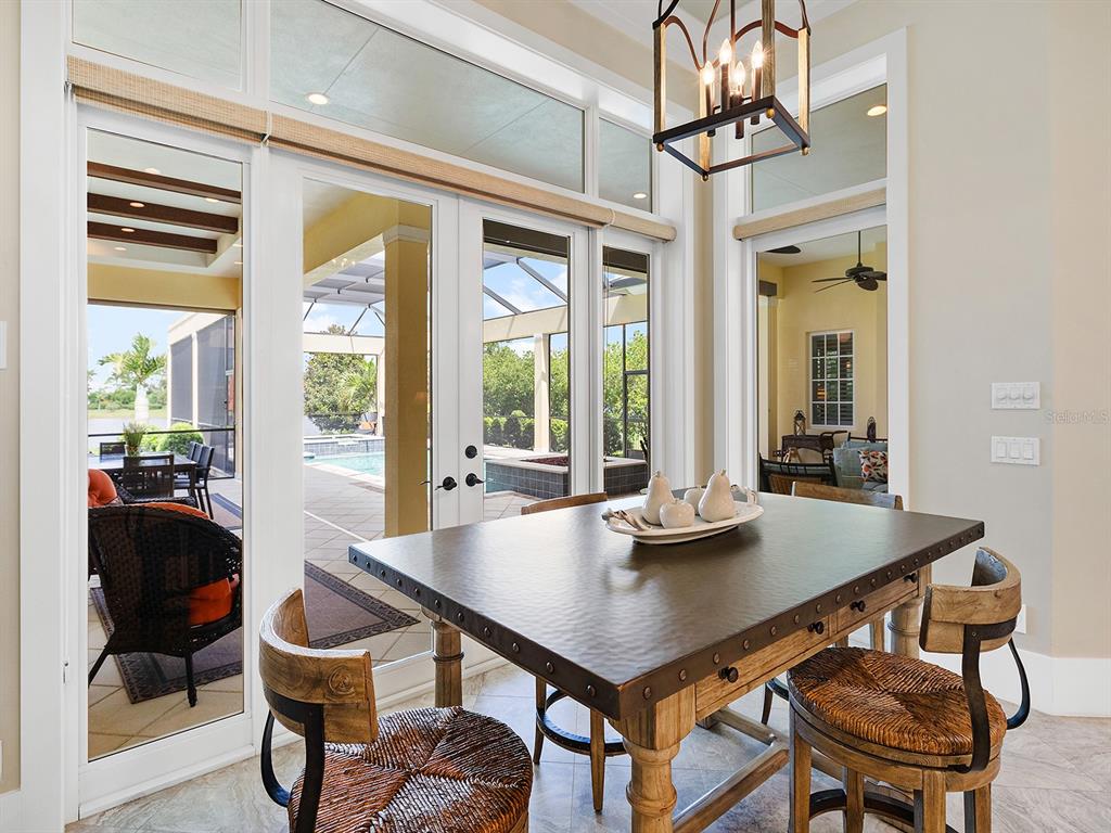 16336 Daysailor Trail Lakewood Ranch, FL 34202 - Photo 33 of 88 a view of a dining room with furniture wooden floor and chandelier