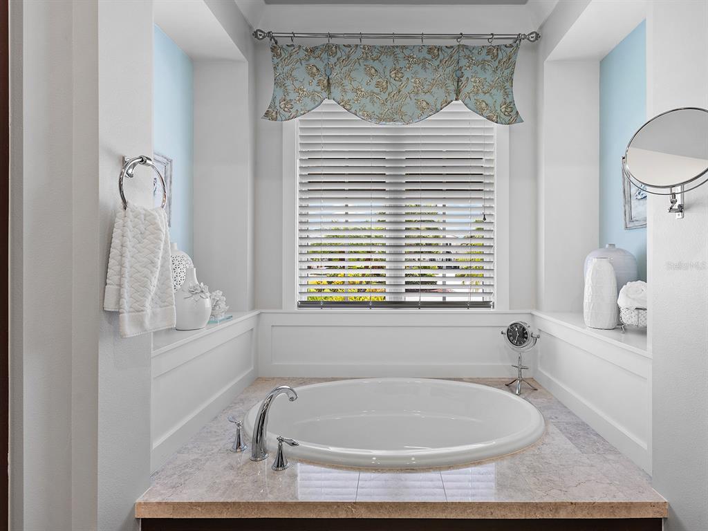 16336 Daysailor Trail Lakewood Ranch, FL 34202 - Photo 43 of 88 a bath tub sitting in a bathroom next to a window