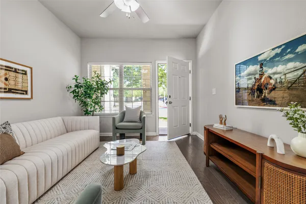 a living room with furniture and a chandelier