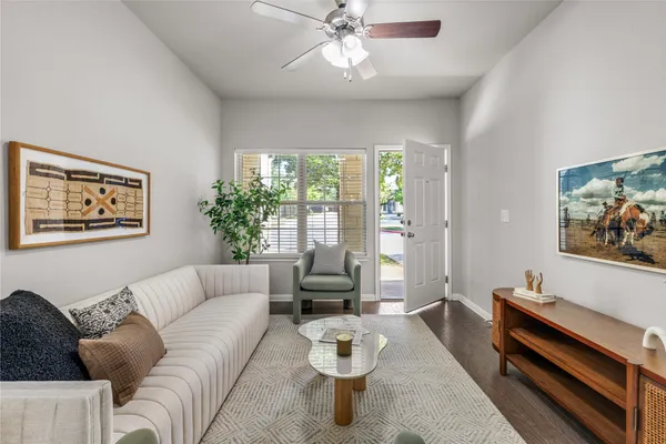 a view of a dining room with furniture a chandelier and wooden floor