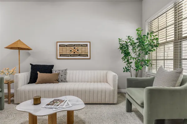 a view of a dining room with furniture a chandelier and wooden floor
