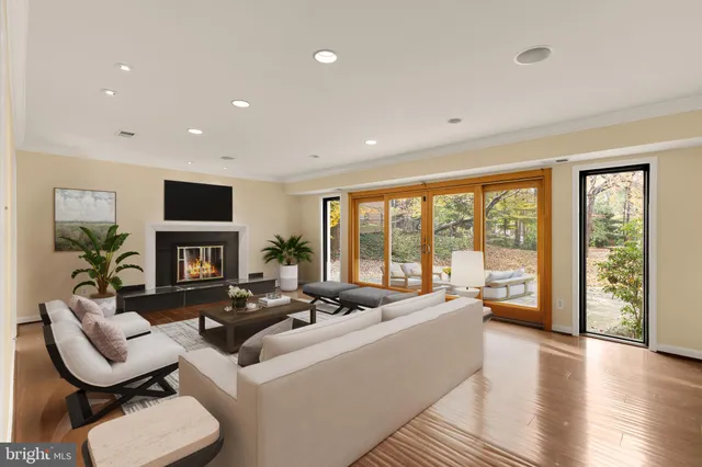 a living room with fireplace furniture and a large window