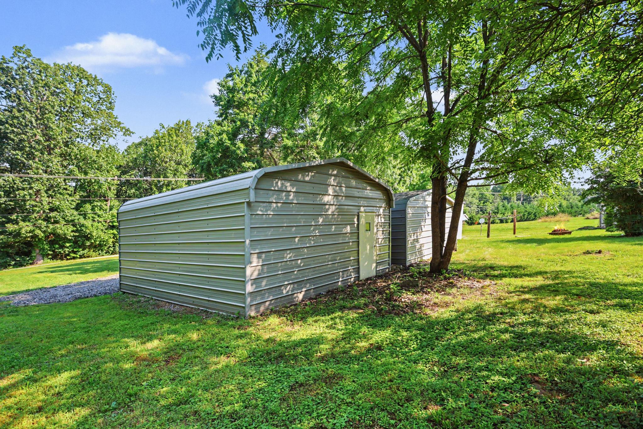 1041 Rohlers Church Road Dover, PA 17315 - Photo 20 of 33 Charming shed nestled in lush greenery.