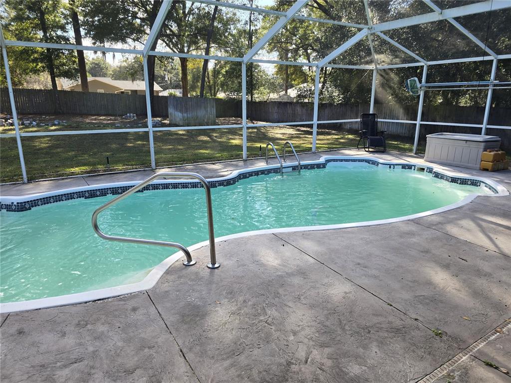 5904 Southwest 107th Street Ocala, FL 34476 - Photo 14 of 33 a view of a swimming pool with a yard