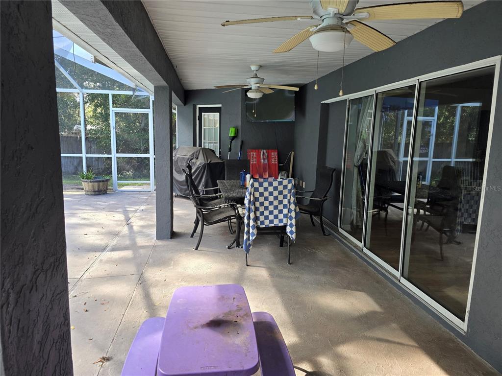 5904 Southwest 107th Street Ocala, FL 34476 - Photo 15 of 33 a view of a porch with dining table and chairs
