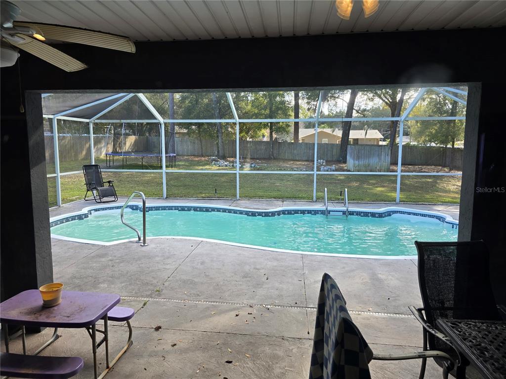 5904 Southwest 107th Street Ocala, FL 34476 - Photo 16 of 33 a view of a porch with furniture and a yard
