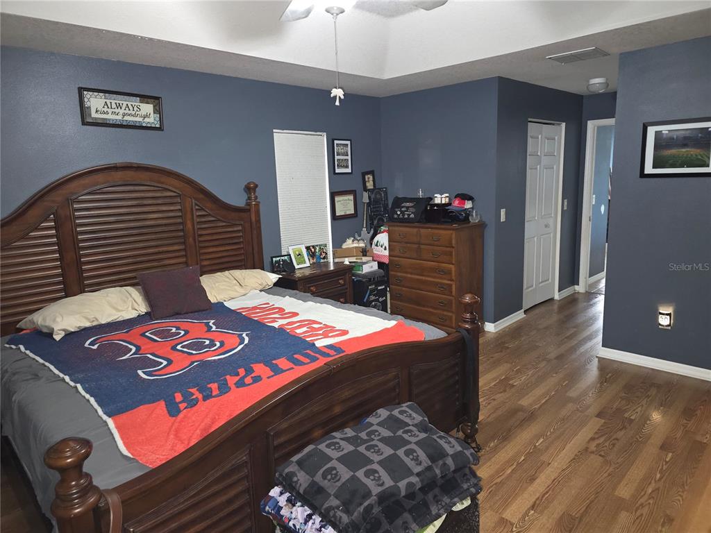 5904 Southwest 107th Street Ocala, FL 34476 - Photo 28 of 33 a bedroom with a bed and a dresser