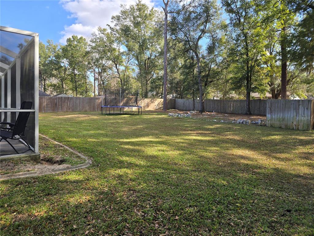 5904 Southwest 107th Street Ocala, FL 34476 - Photo 6 of 33 a view of a field with a tree