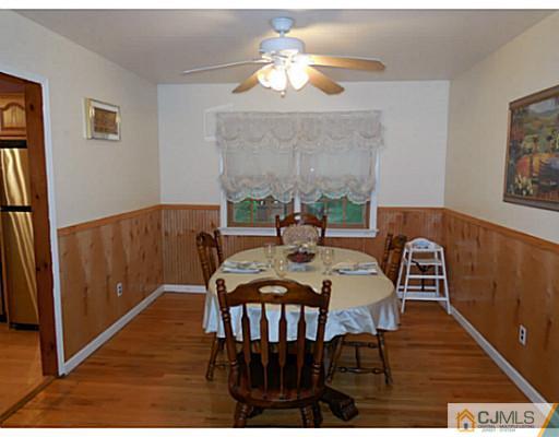 123 5th Street Middlesex, NJ 08846 - Photo 3 of 9 a view of a dining room with furniture wooden floor and chandelier