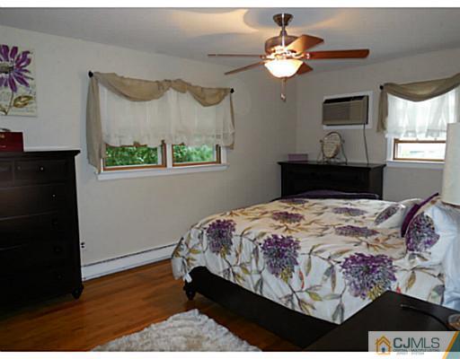 123 5th Street Middlesex, NJ 08846 - Photo 5 of 9 a bedroom with a bed and a chandelier