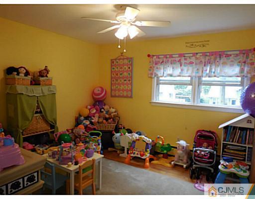 123 5th Street Middlesex, NJ 08846 - Photo 7 of 9 a room with furniture a chandelier and a window