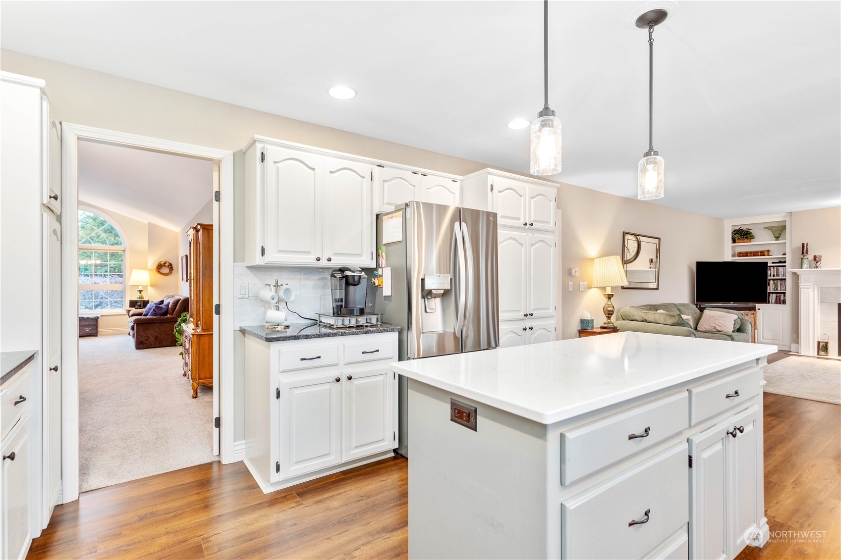 212 Springview Drive Lynden, WA 98264 - Photo 11 of 40 a kitchen with a refrigerator sink and white cabinets