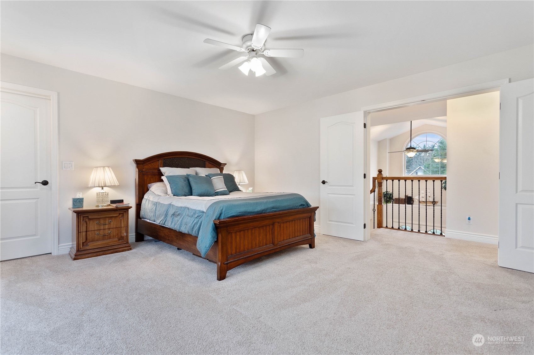 212 Springview Drive Lynden, WA 98264 - Photo 23 of 40 a spacious bedroom with a bed and a chandelier