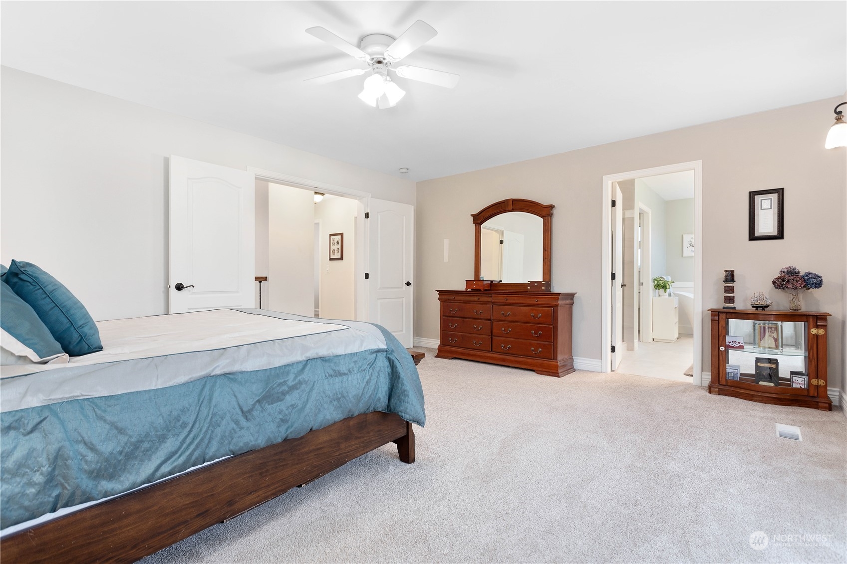 212 Springview Drive Lynden, WA 98264 - Photo 25 of 40 a spacious bedroom with a bed and a chandelier