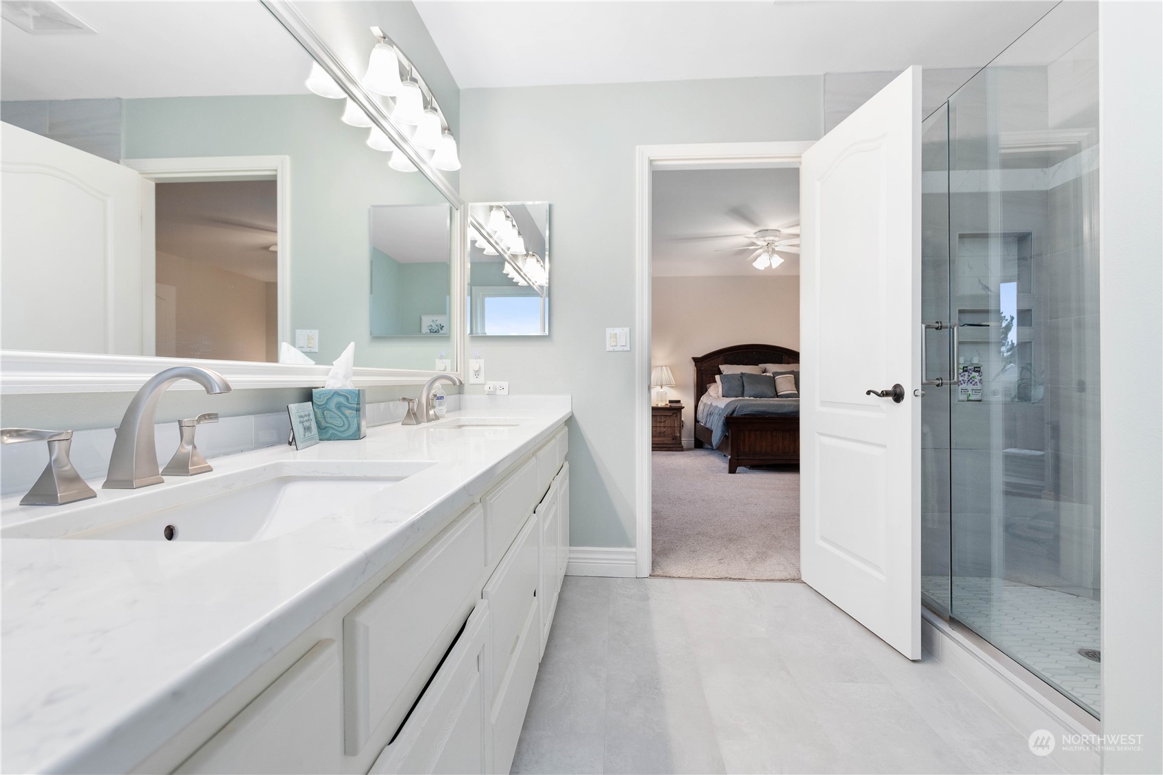 212 Springview Drive Lynden, WA 98264 - Photo 26 of 40 a en suite bathroom with a double vanity sink a mirror and a shower