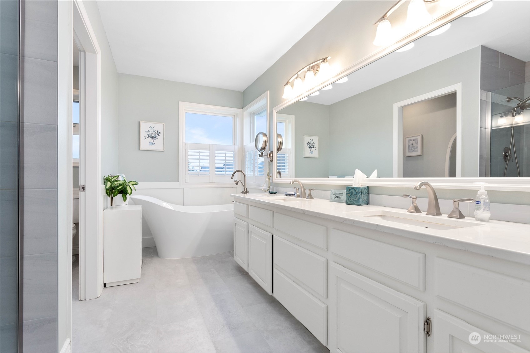 212 Springview Drive Lynden, WA 98264 - Photo 27 of 40 a large white bathroom with a double vanity sink a mirror and a bathtub